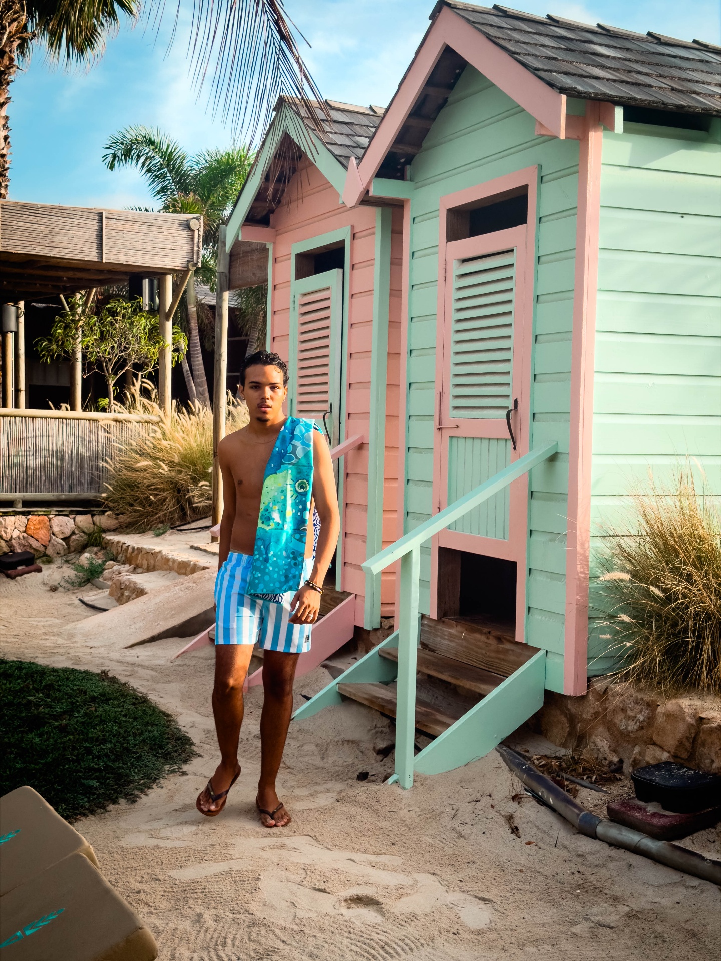 BRO Men's Fashion — striped swim shorts by the pastel beach huts